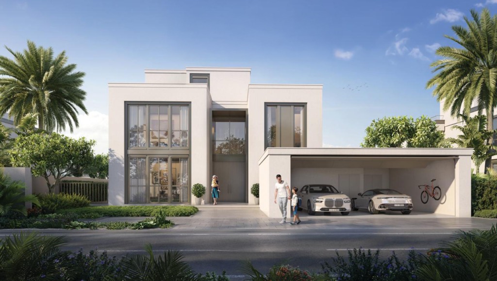 Moderne 5-Schlafzimmer-Villa in Mirage at the Oasis von Emaar, Dubailand. Die exklusive Immobilie bietet eine minimalistische Architektur mit klaren Linien, großen Fensterfronten und einer eleganten weißen Fassade. Die Villa verfügt über eine geräumige Doppelgarage mit Luxusfahrzeugen, einen stilvollen Eingangsbereich und eine grüne Umgebung mit Palmen und gepflegter Landschaftsgestaltung. Ideal für Käufer, die eine hochwertige Immobilie in Dubai suchen. Jetzt auf nikvandamme.ae entdecken.