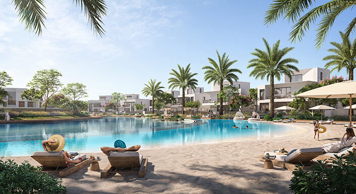 Exklusive Strand- und Poolanlage in Mirage at the Oasis von Emaar, Dubailand. Diese luxuriöse Wohnanlage bietet einen künstlichen Strand mit kristallklarem Wasser, umgeben von Palmen, stilvollen Sonnenliegen und privaten Villen im Hintergrund. Ein idyllischer Rückzugsort für Bewohner, die höchsten Komfort und Erholung in einer gehobenen Umgebung genießen möchten. Jetzt auf nikvandamme.ae entdecken.